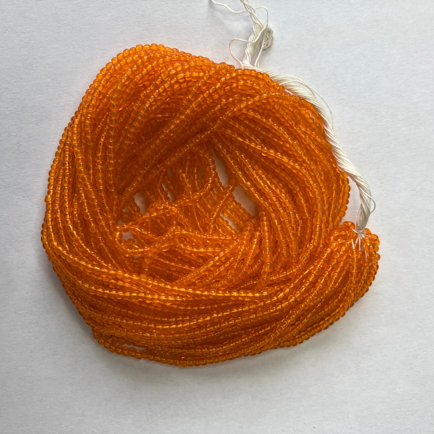11/0 Transparent Orange Seed Beads – Hank